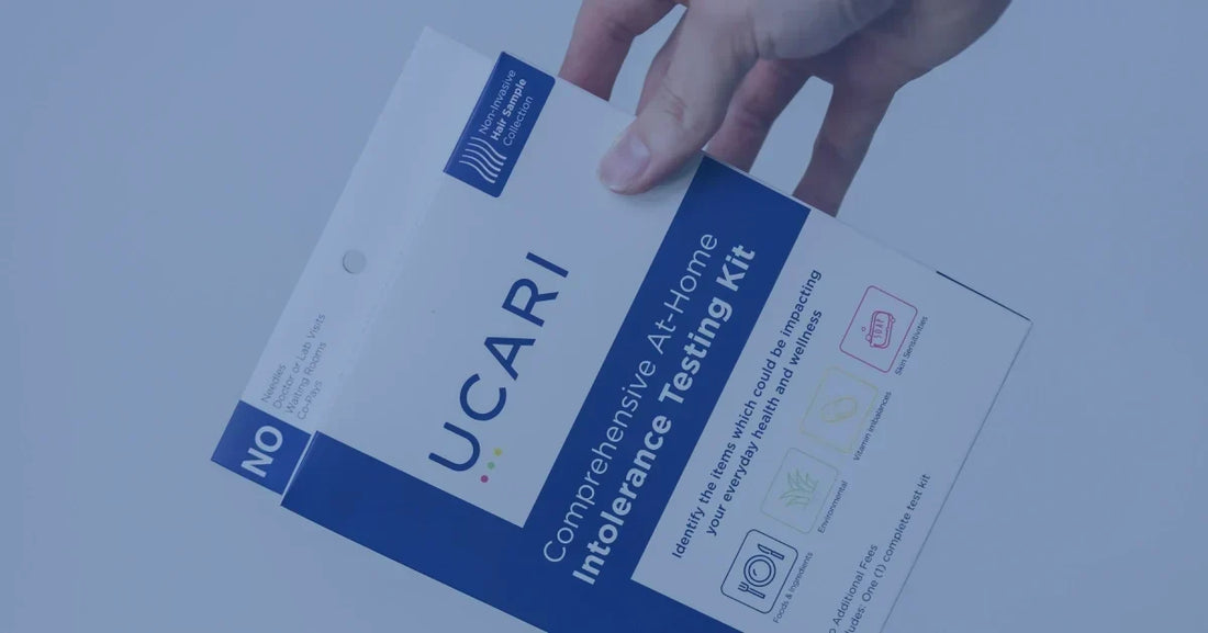 A hand holding a UCARI Comprehensive At-Home Intolerance Testing Kit box.