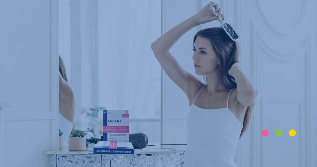 woman pulling out her hair for at-home food intolerance test with UCARI's test kit on the table