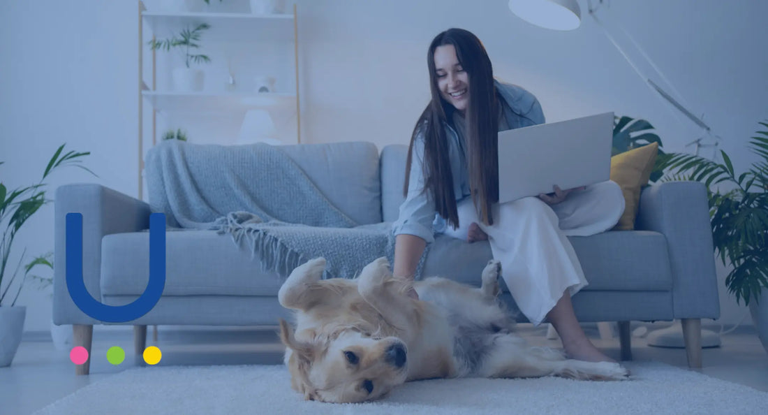 a happy woman playing with a dog and screening reports of UCARI food intolerance test in laptop 